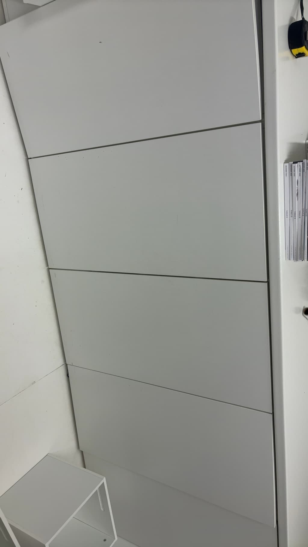 White storage cabinet with hinged front panels